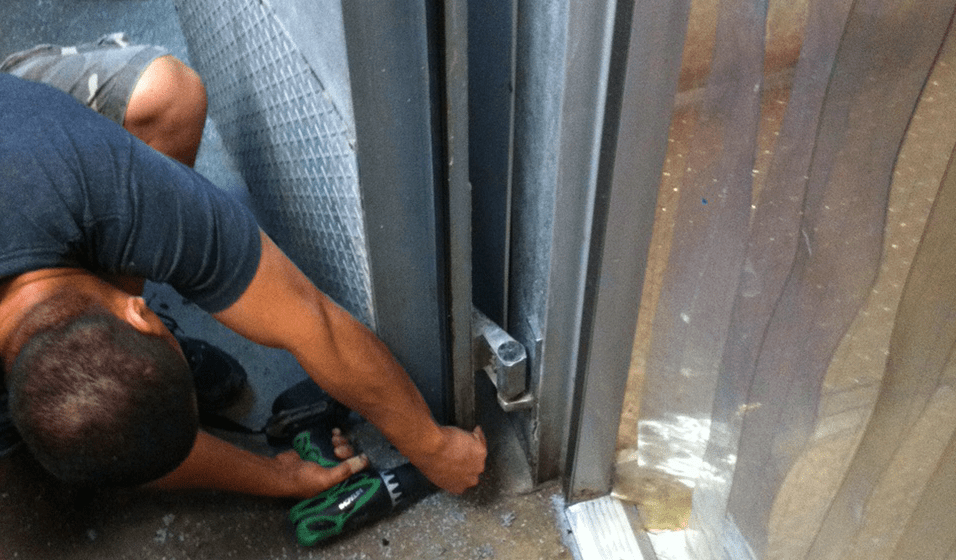 A man is working on the outside of a building.