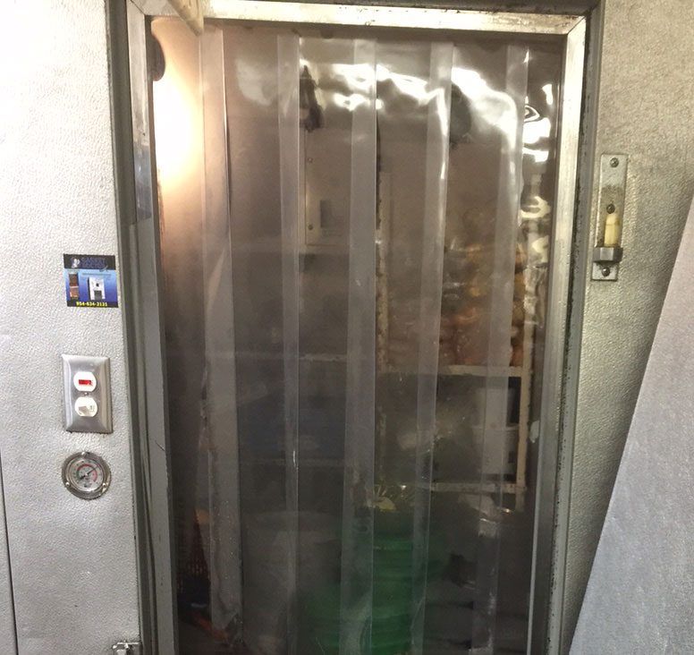A door of an elevator with a plastic curtain.