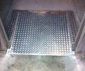 A metal floor with some type of diamond plate.