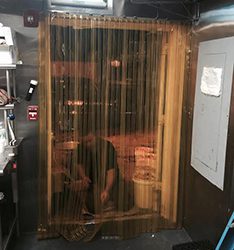 A man standing in front of a wooden door.