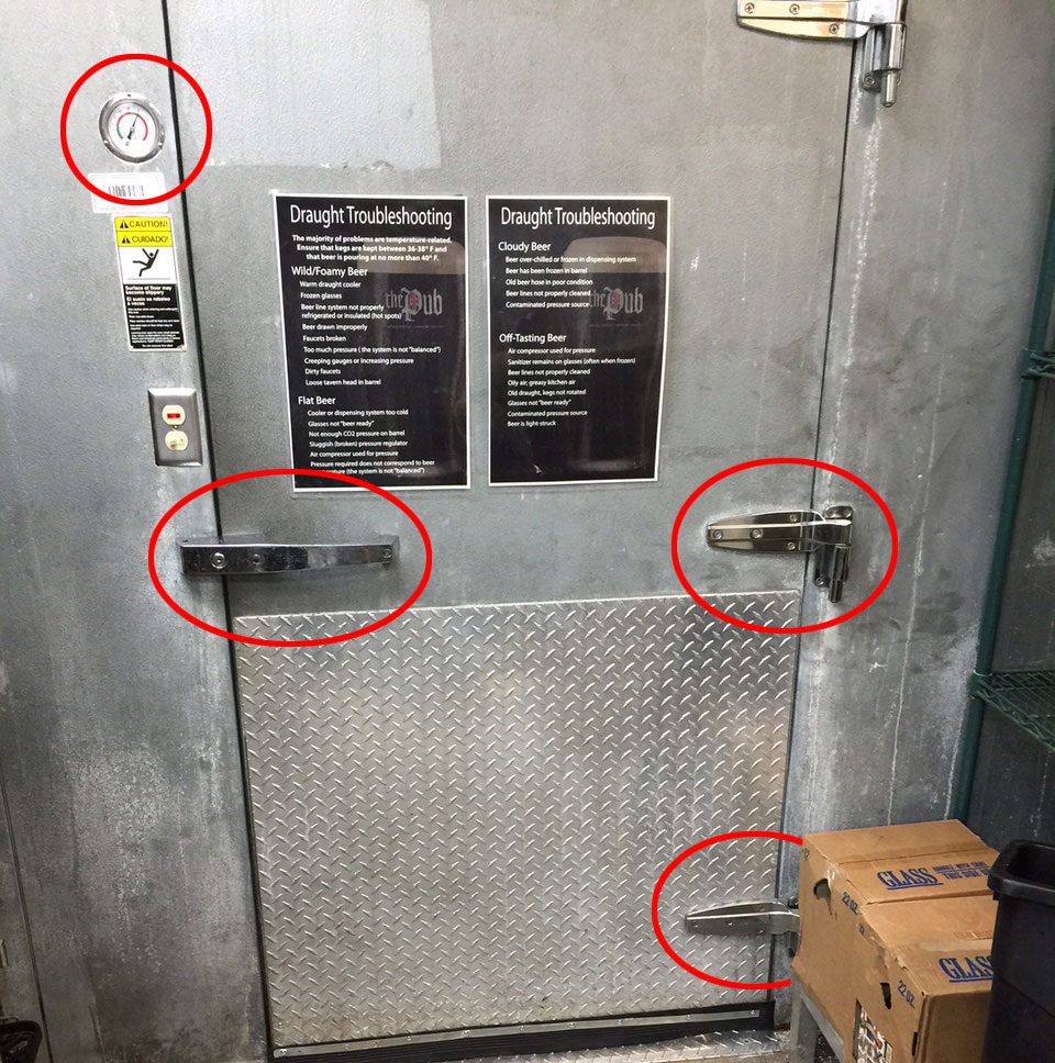 A door with two red circles on it and three boxes in front of the doors.