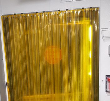 A yellow curtain is shown in front of a window.